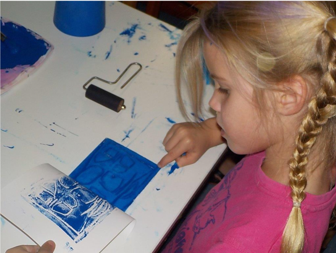 A child printmaking at Bundaberg Regional Gallery
